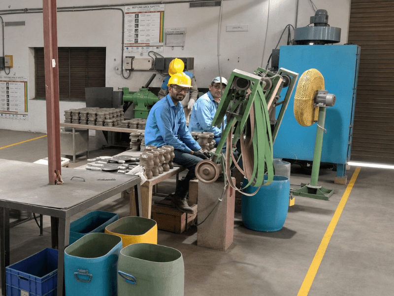 Workers at grinding and finishing stations in Precimetal's fettling area